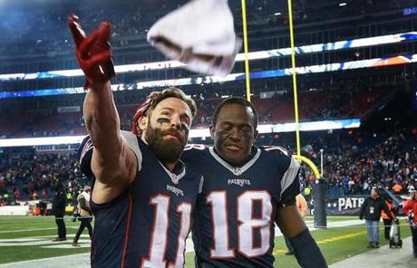 Julian Edelman (11, left) got a pat on the head from teammate Mathew Slater as they left the field following the victory. 
